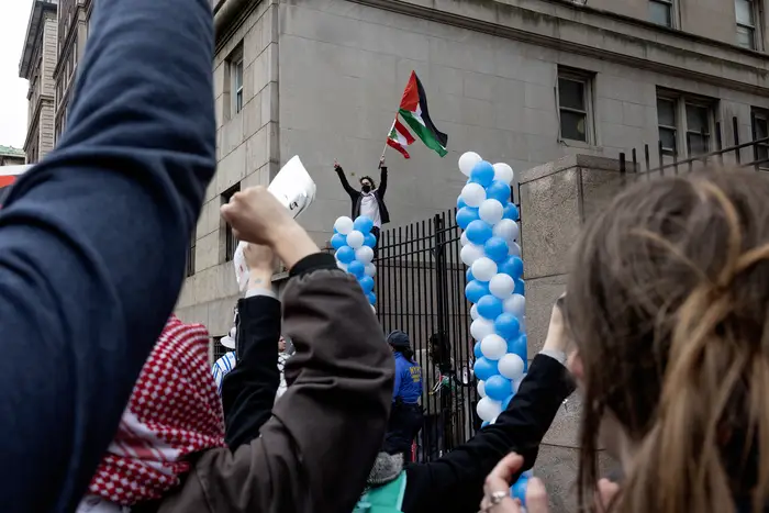 Pro-Palestinian demonstrators show their support for Columbia students at the locked gates of the University, April 21, 2024 in New York City.